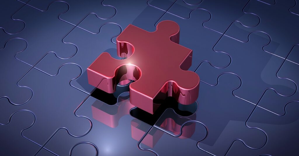 Neurodiversität und Trauma im Business: Traumasensibles Coaching Karen Wiltner Coaching Puzzleteile, die zusammengefügt werden, symbolisieren das Lösen emotionaler Blockaden und das Finden von Balance im Business durch traumasensibles Coaching.